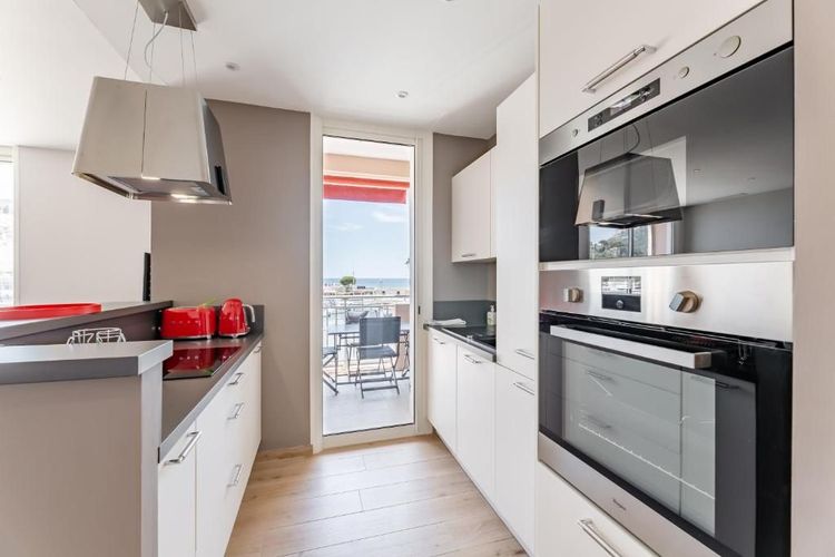 The open-plan kitchen has access to the balcony